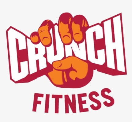 A stylized orange hand grips the bold red and white word "CRUNCH," with "FITNESS" written below in red capital letters.