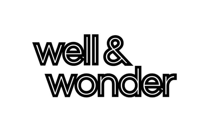 The image features the words "well & wonder" in bold, black, lowercase letters on a white background. The text has a thick outline giving it a modern, graphic look.