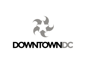 Logo with a white star surrounded by five gray crescent shapes forming a circular pattern above the text “DOWNTOWN DC” in bold, black letters on a light background.