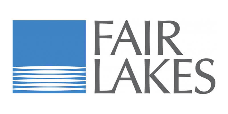 Logo for Fair Lakes featuring a blue square with white horizontal lines at the bottom, resembling water, next to the words "FAIR LAKES" in stylized gray capital letters.