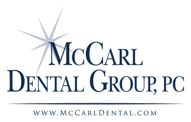Logo for McCarl Dental Group, PC, featuring the business name in dark blue text with a starburst graphic beside the "M". The website "www.McCarlDental.com" appears below a blue line.