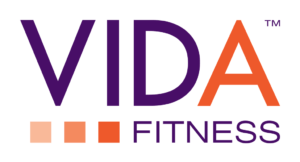 Logo for VIDA Fitness. "VIDA" is written in large purple and orange letters, with three shaded orange squares below, followed by the word "FITNESS" in purple capital letters.