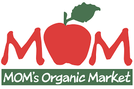 Logo for MOM’s Organic Market featuring “MOM” in red letters with an apple as the “O” and a green leaf on top. Below, "MOM's Organic Market" is written on a green rectangle.