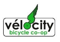 Logo for Velocity Bicycle Co-op. The word "velocity" is written in black, with a green bicycle wheel replacing the "o" and a green wing attached to it. "Bicycle co-op" is written in green underneath.